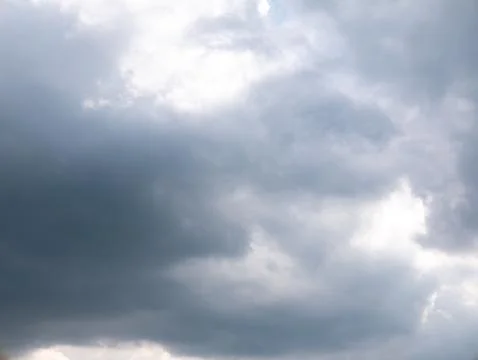 Dramatic Storm Clouds with Sunlight Breaking Through, Moody Sky Background 库存照片