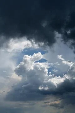 Dramatic Storm Clouds with Sunlight Breaking Through Before Rain. Weather. Stock Photos