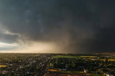 Dramatic storm clouds sweep across the sky at sunset. 스톡 사진