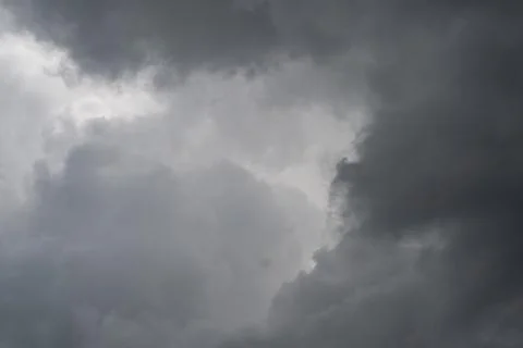 Dramatic storm contrast with deep shadows, towering cloud masses and sharp ed Stock Photos