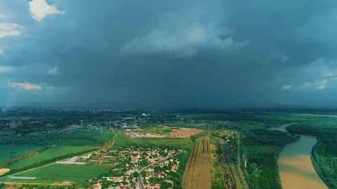Dramatic storm dark rainy clouds moving over the lush summer rural landscape. Stock Footage 125481385