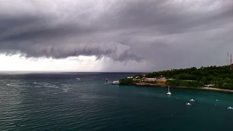 Dramatic Storm Front Rolling over Tropical Harbor with Dark Clouds and Stock Footage 334204978