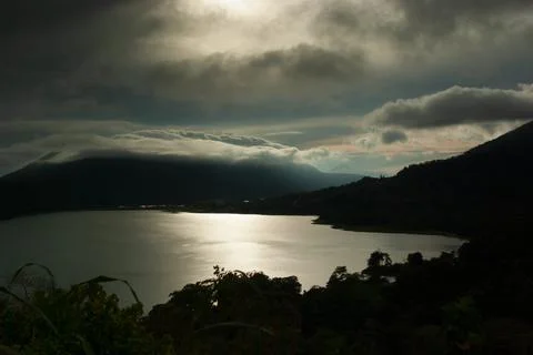 Dramatic storm in mountains landscape - heavy rain fluffy clouds and sunbeams Stock Photos