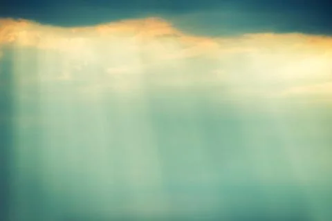 Dramatic storm sky with dark clouds and bright sunbeams Stock Photos