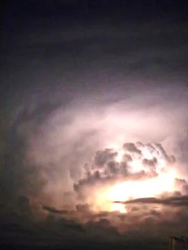 A dramatic storm sky with dark, moody clouds gathering at sunset. Stock Photos