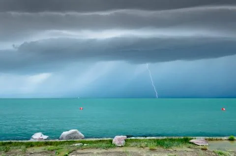 Dramatic before storm view at a turquoise lake Stock Photos