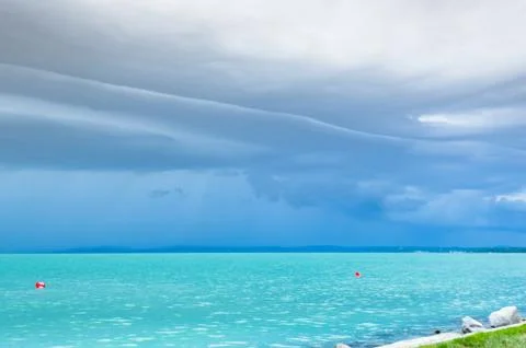 Dramatic before storm view at a turquoise lake Stock Photos