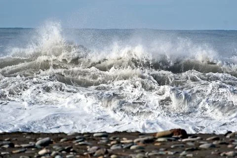 Dramatic storm waves crashing on a pebble beach, Black Sea coast Stock Photos