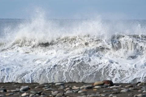 Dramatic storm waves crashing on a pebble beach, Black Sea coast Stock Photos