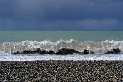Dramatic storm waves crashing on a pebble beach, Black Sea coast Stock Photos