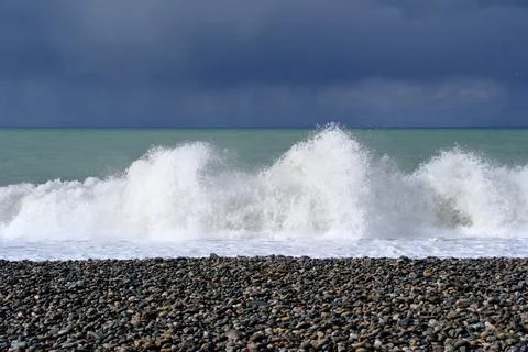Dramatic storm waves crashing on a pebble beach, Black Sea coast Stock Photos