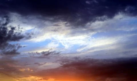 Dramatic stormy clouds with abeautiful amazing colors and a sunset with no la Stock Photos