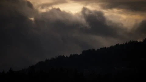 Dramatic stormy clouds moving above the mountain hill at sunrise Stock Footage 337675897