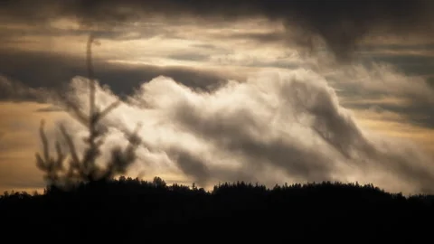 Dramatic stormy clouds moving in the morning sky at sunrise Stock Footage 337675345