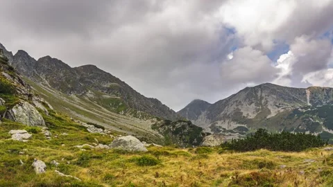 Dramatic stormy clouds moving over alps mountains in autumn nature Time lapse Stock Footage 292918284
