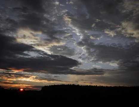 Dramatic Stormy Clouds Over a Sunset Horizon Stock Photos