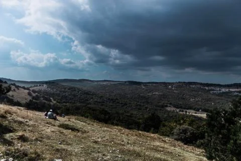 Dramatic stormy cloudy sky aproaching a hill Stock Photos