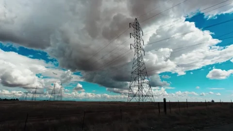 Dramatic Stormy Cumulonimbus Clouds Over High-Voltage Power Lines and Dry Farmla Stock Footage 318623053