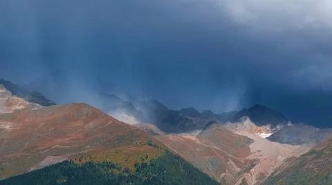 Dramatic stormy sky blue sky with rain over mountains 스톡 사진