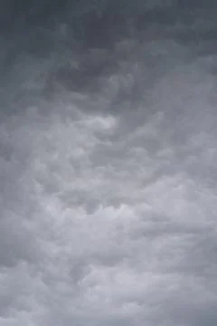 Dramatic stormy sky with dark clouds. Gray clouds before a thunderstorm. Stock Photos
