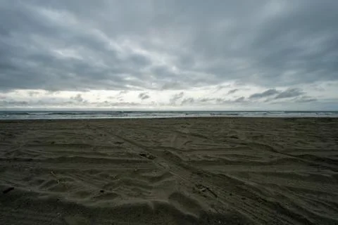 A Dramatic Stormy Sky Over a Dark Beach Stock Photos