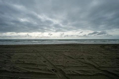 A Dramatic Stormy Sky Over a Dark Beach Stock Photos
