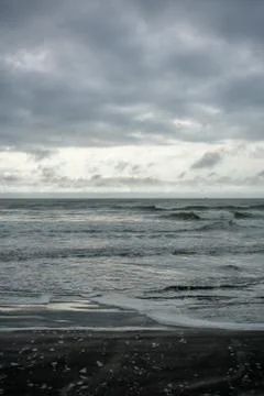A Dramatic Stormy Sky Over a Dark Beach Stock Photos