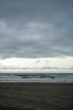 A Dramatic Stormy Sky Over a Dark Beach Stock Photos