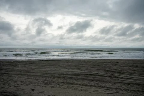 A Dramatic Stormy Sky Over a Dark Beach Stock Photos