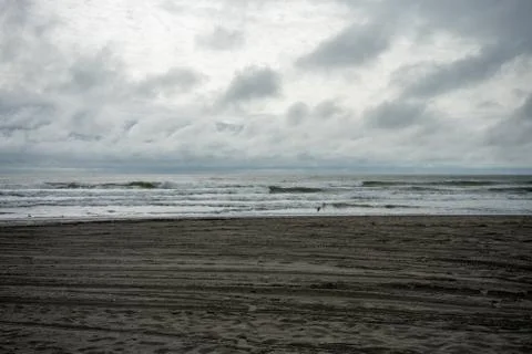 A Dramatic Stormy Sky Over a Dark Beach Stock Photos