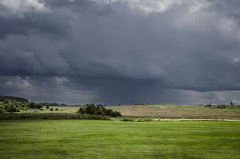  Dramatic stormy sky over green meadow. Nature composition. Stock Photos
