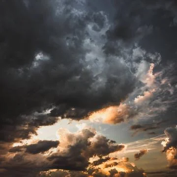 Dramatic stormy sky at sunset with dark clouds Dramatic stormy sky at suns... Stock Photos