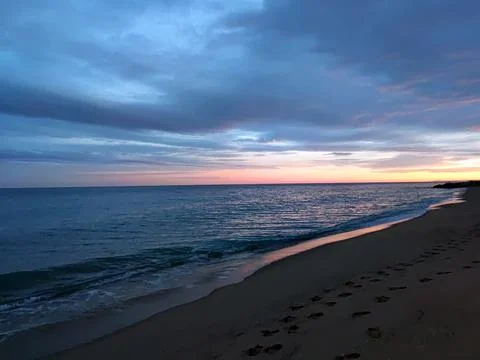 Dramatic stormy sunset over the sea horizon, seascape Stock Photos