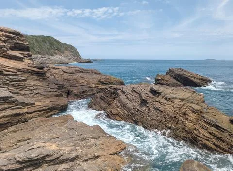 Dramatic Stratified Cliffs of Búzios Coastline: Geological Rock Formations and D Stock Photos