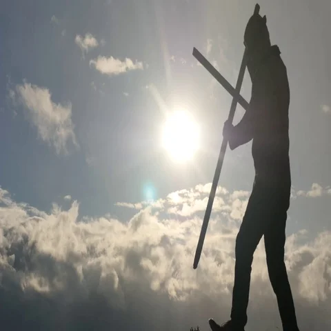 Dramatic subject- mans silhouette fix a cross slow motion Stock Footage 69534073