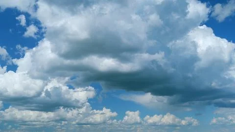 Dramatic Summer cloudscape. Blue sky white clouds. Changing cloudscape. Time Stock Photos