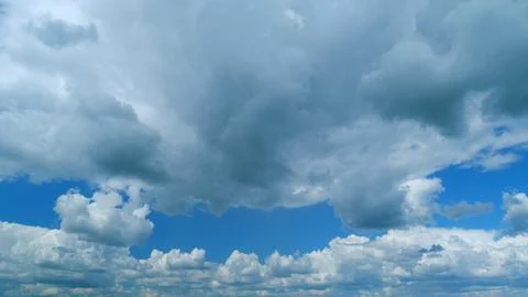 Dramatic Summer cloudscape. Blue sky white clouds. Changing cloudscape. Time Stock Photos