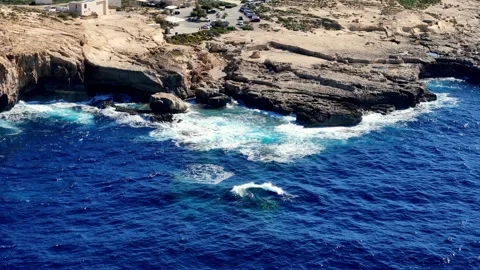 Dramatic Summer Drone Perspective of Rugged Limestone Cliffs and Crashing Waves Stock Footage 328214998