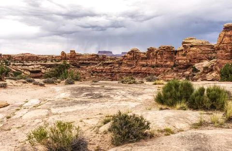 Dramatic Summer Rain Storm Over Rugged Desert Sandstone Cliffs in Canyonlands Na Stock Photos