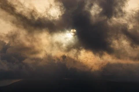 Dramatic Sun Hidden by Dark Clouds Stock Photos