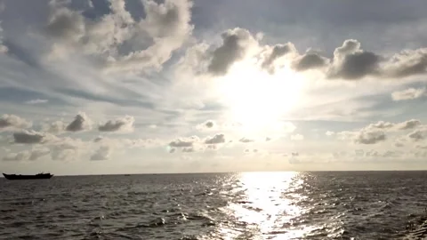 Dramatic Sun Over Meghna River with Sparkling Water, Clouds and Boat Stock Footage 343196857