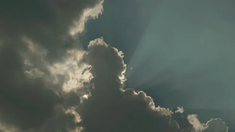 Dramatic Sun Rays Breaking Through Moving Dark Clouds with Sky Reflection Stock Footage 330512939