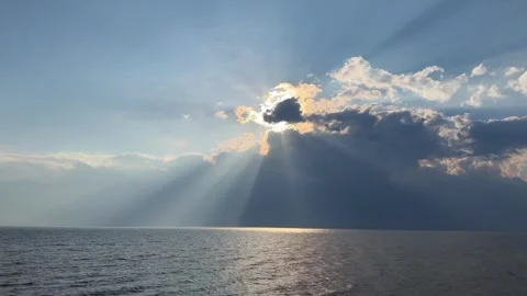 Dramatic sun rays breaking through clouds over Erhai Lake Dali 動画素材 333749381