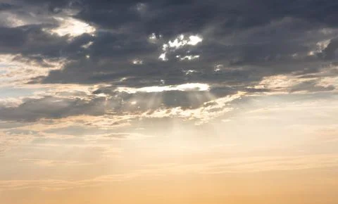 Dramatic sun rays breaking through some clouds at sunset Foto stock