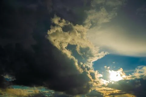 Dramatic Sun Rays Breaking Through Dark Storm Clouds Stock Photos