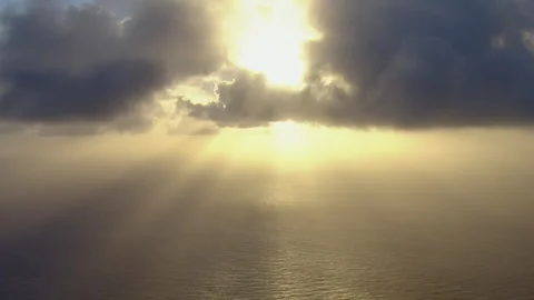 Dramatic sun rays shining through clouds over the ocean Stock-Footage 333150555