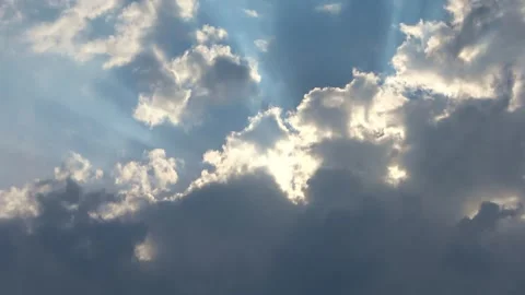 Dramatic sun rays shining through clouds Stock Footage 341407100