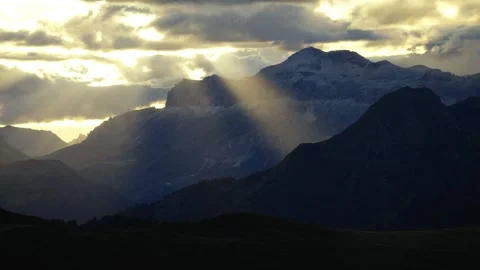 Dramatic Sun Rays through Clouds over Dark Mountains, Dolomites Video stock 316821182