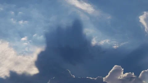 Dramatic sunbeams breaking through white cumulus clouds Stock Footage 318959376