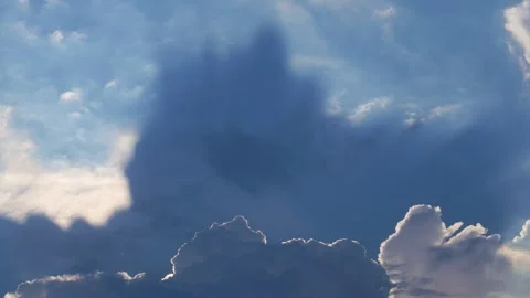 Dramatic sunbeams breaking through white cumulus clouds Stock Footage 324902675